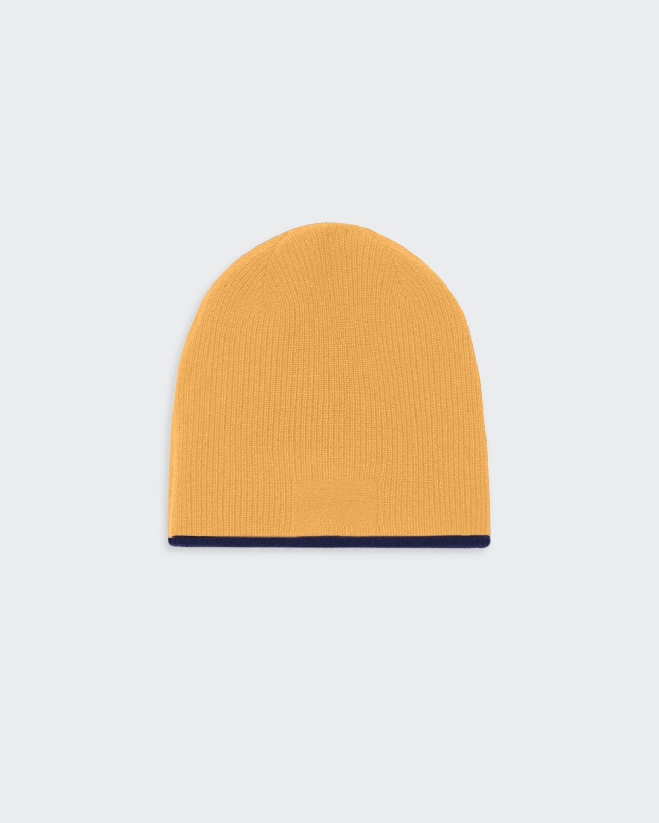 Reversible cashmere beanie hat in midnight blue and sungold colors.