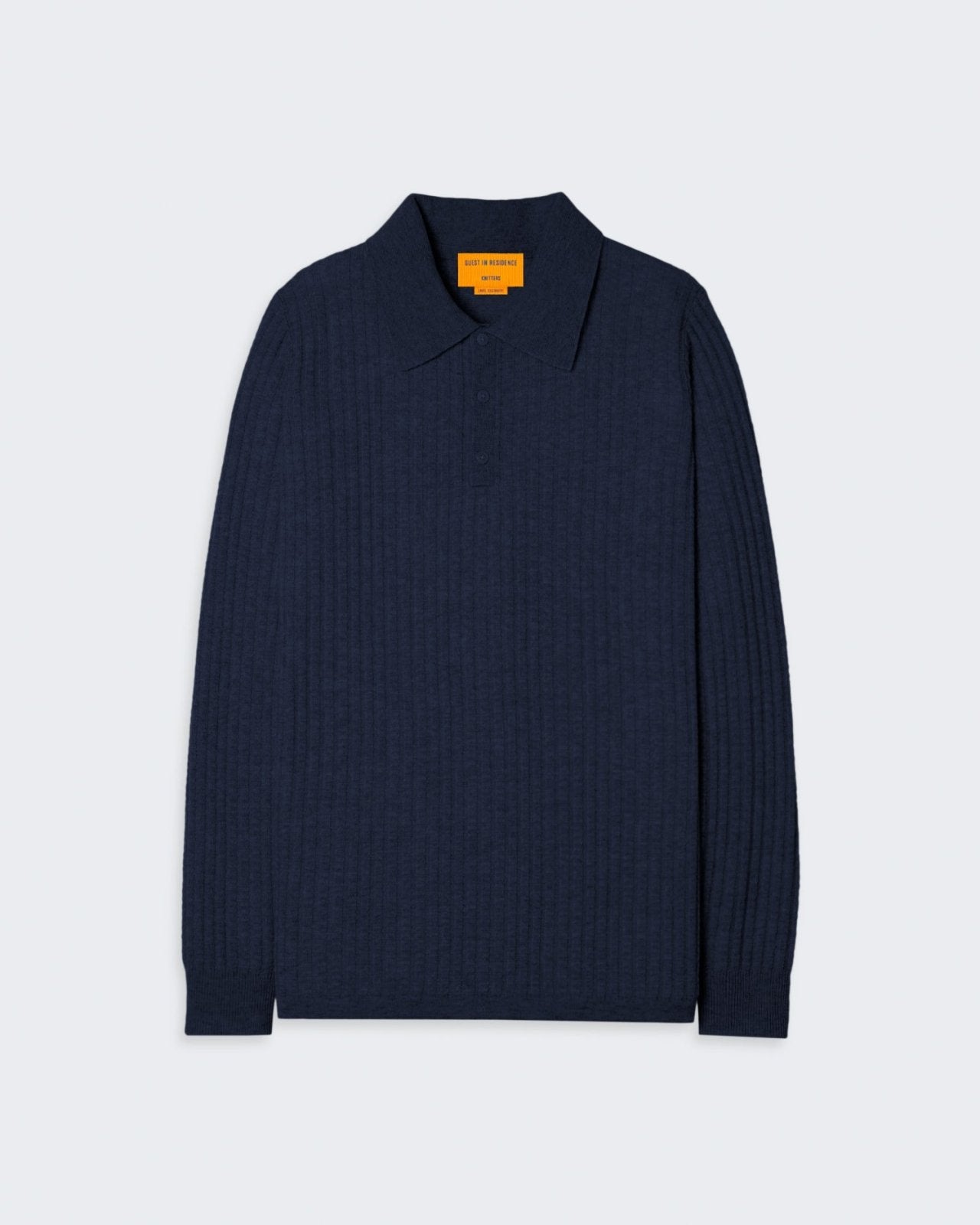 Navy colored men's cashmere polo shirt with a waffle body stitch, collar, and three-button placket.