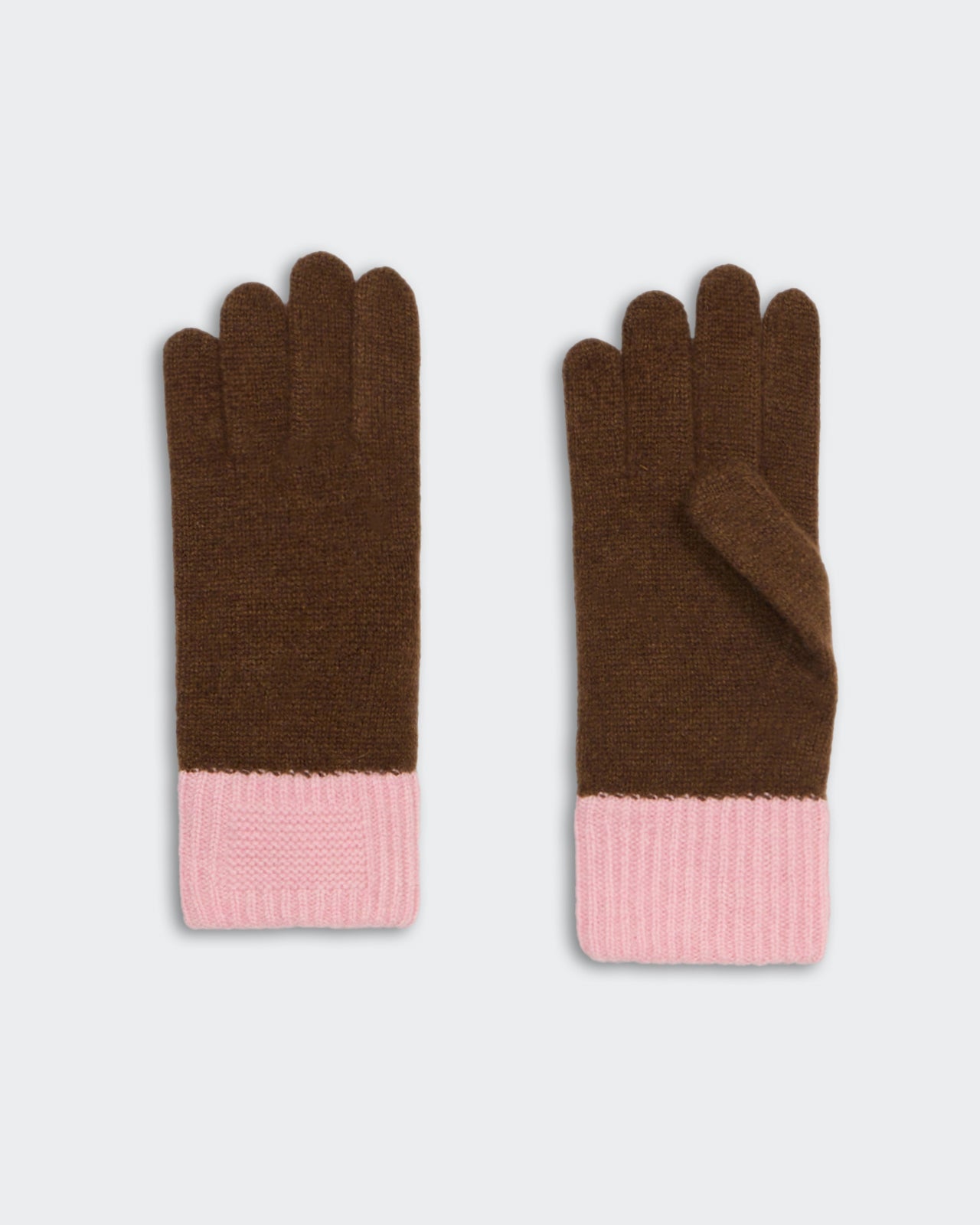Chestnut brown soft knit gloves with pink ribbed cuffs laid flat on a light background