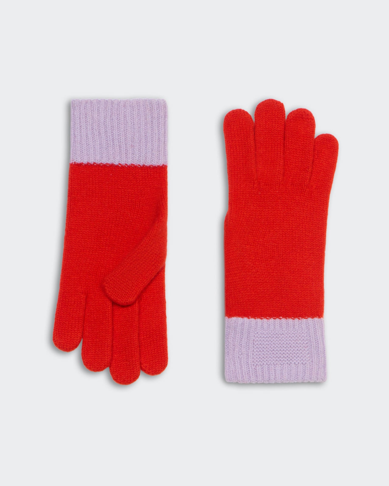 Pair of knit gloves in bright chili red with dusky lavender cuffs laid flat on white background