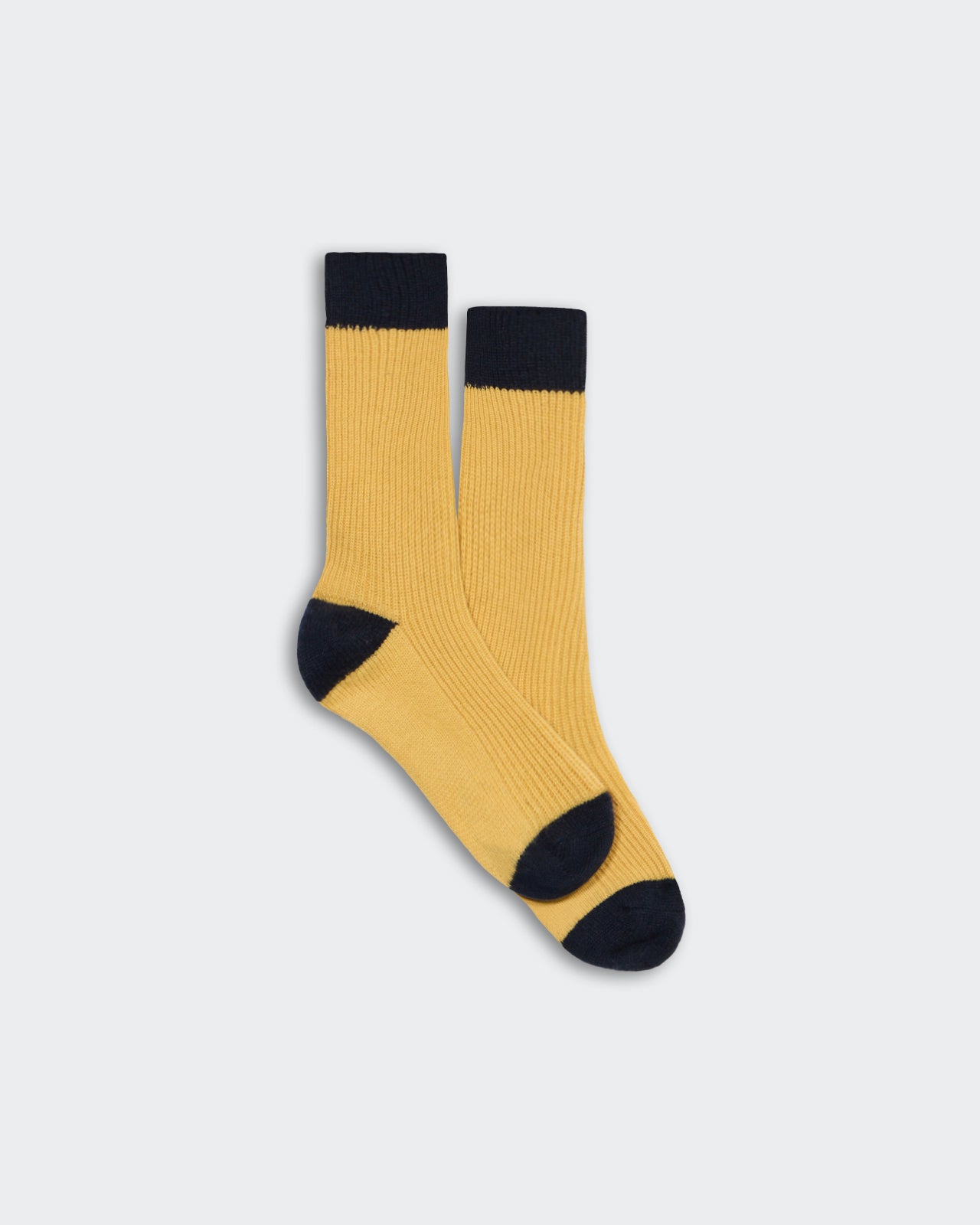 Unisex soft cashmere socks in yellow with midnight blue toes, heels, and cuffs, one size fits all design.