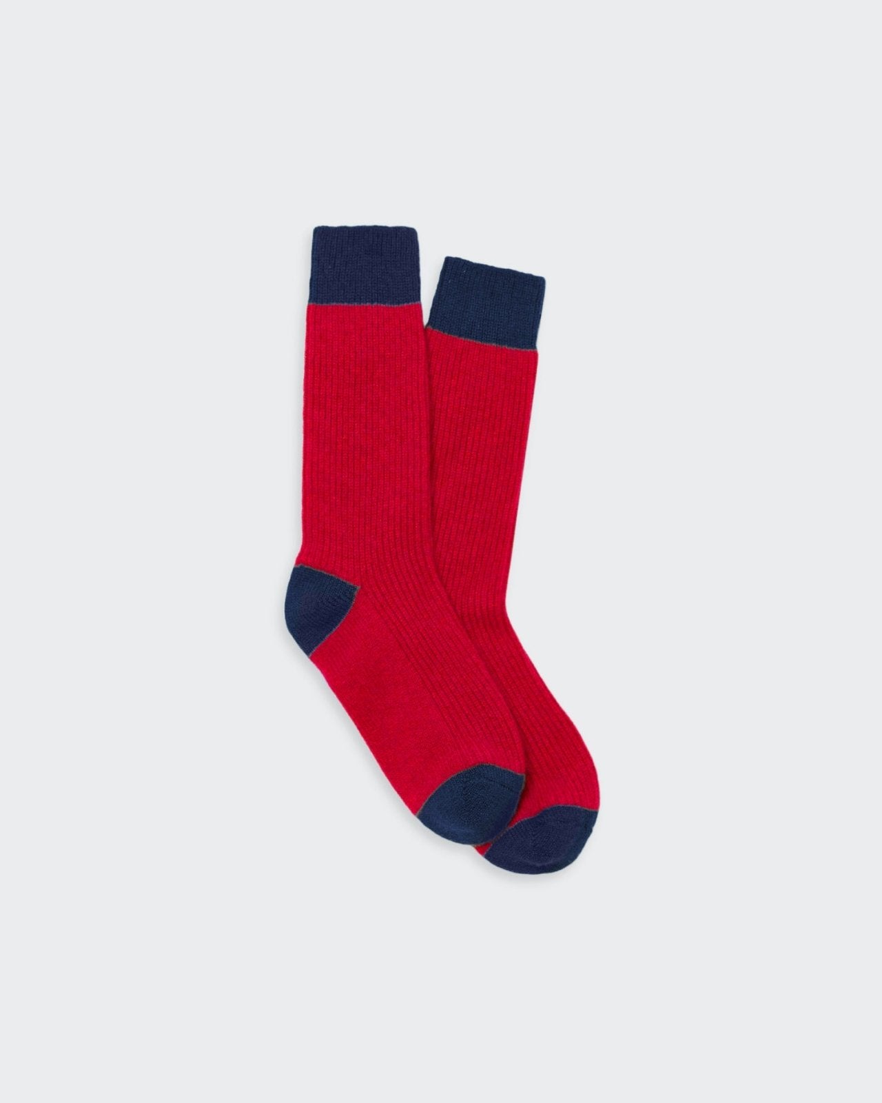 Cozy cashmere socks in vibrant red and navy blue with a color-blocked design.