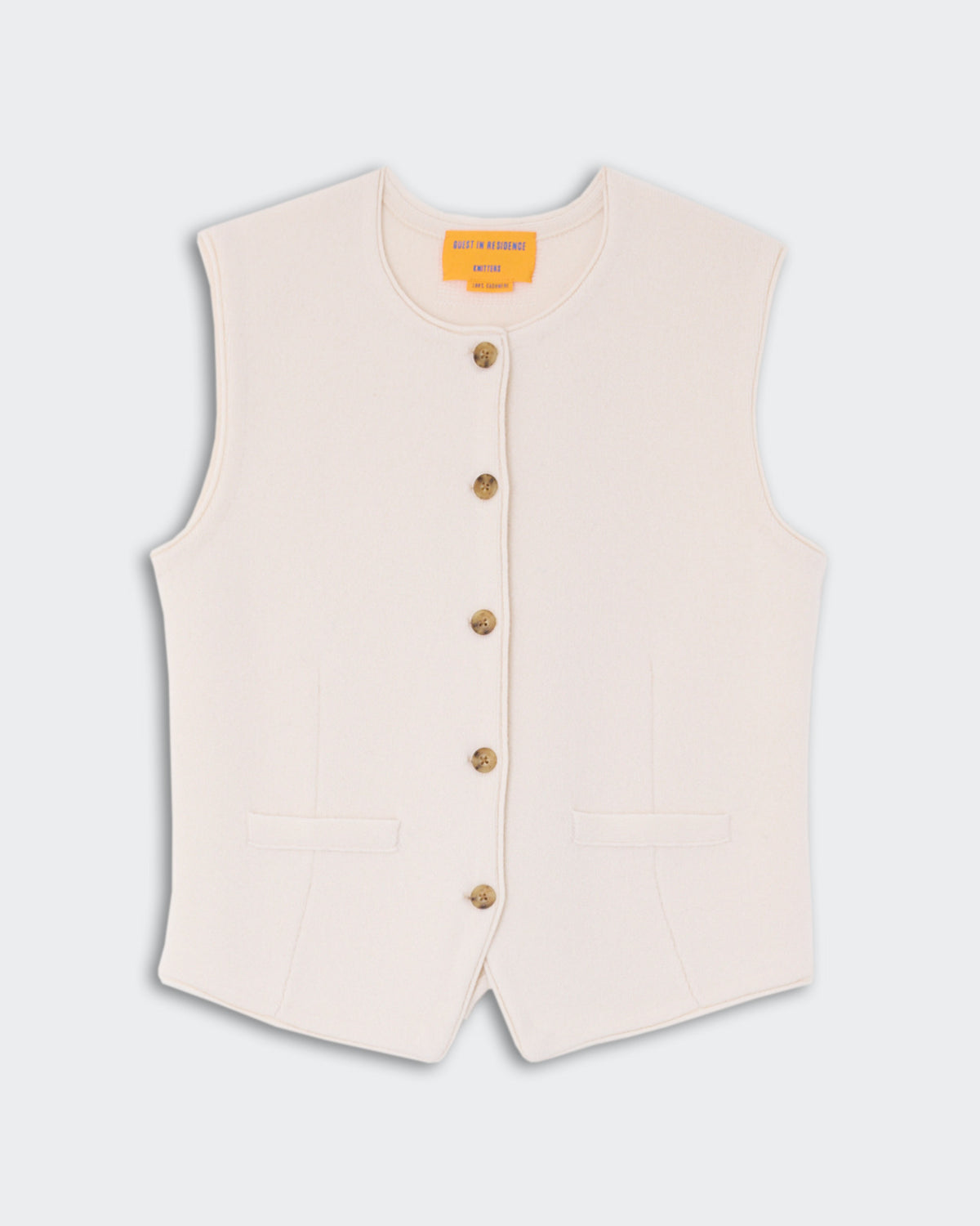 Tailored Crew Vest - Cream with a sleeveless design, front button closure, and two front pockets, made from soft cashmere fabric.