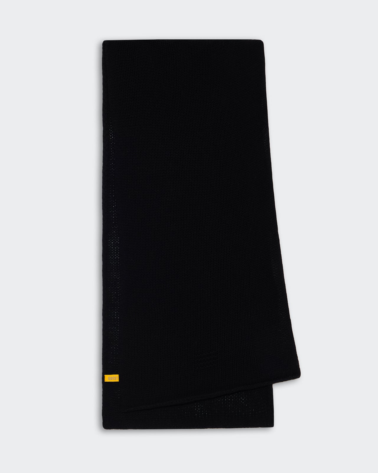 The Blanket Scarf - Black folded open knit jersey scarf made of lightweight 100% cashmere with subtle branding