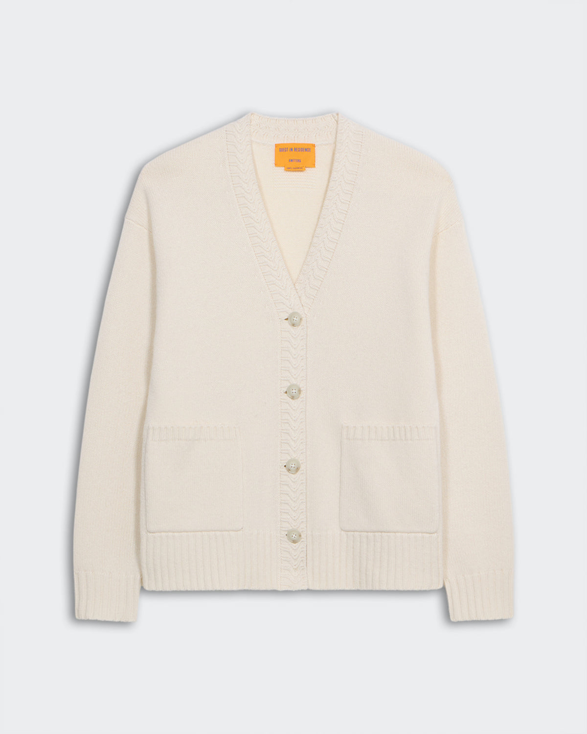 The Cardigan - Cream, medium-weight 100% cashmere knit with five buttons, ribbed cuffs, hem, and two front pockets.