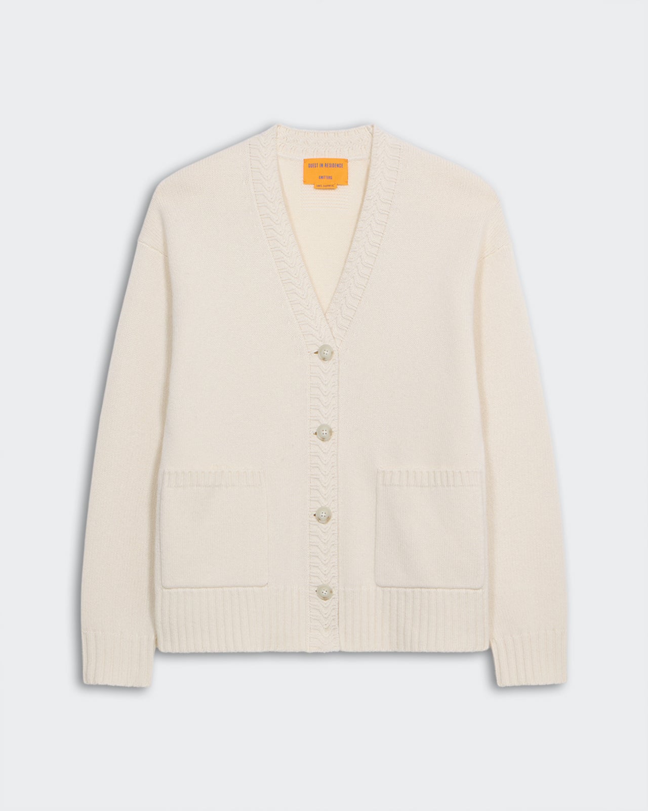 The Cardigan - Cream, medium-weight 100% cashmere knit with five buttons, ribbed cuffs, hem, and two front pockets.