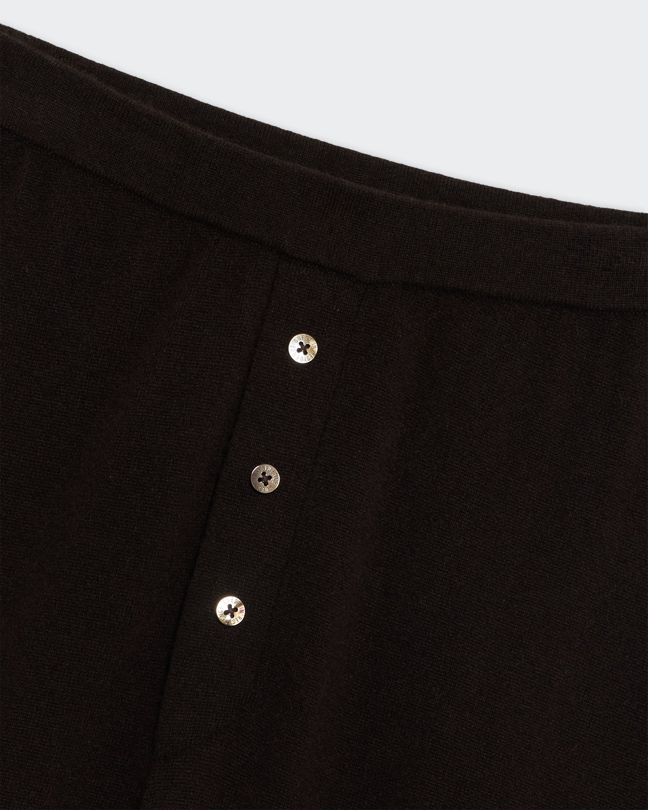 Close-up of burnt cocoa Everywear Pant featuring elastic waistband and three-button placket faux closure in cashmere knit.