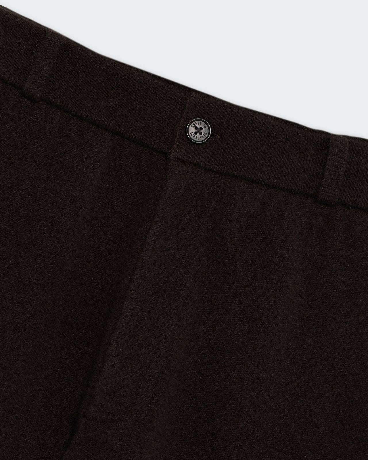 Tailored Trouser - Burnt Cocoa close-up of waistband with button and belt loops in dark brown fabric texture.