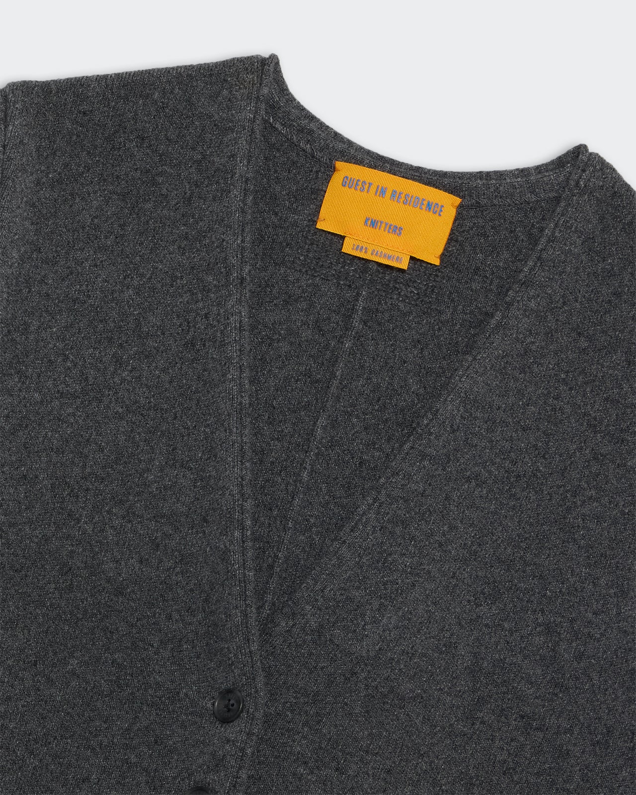 Tailored Vest - Charcoal in soft knit fabric with button closure and orange inner label detail.
