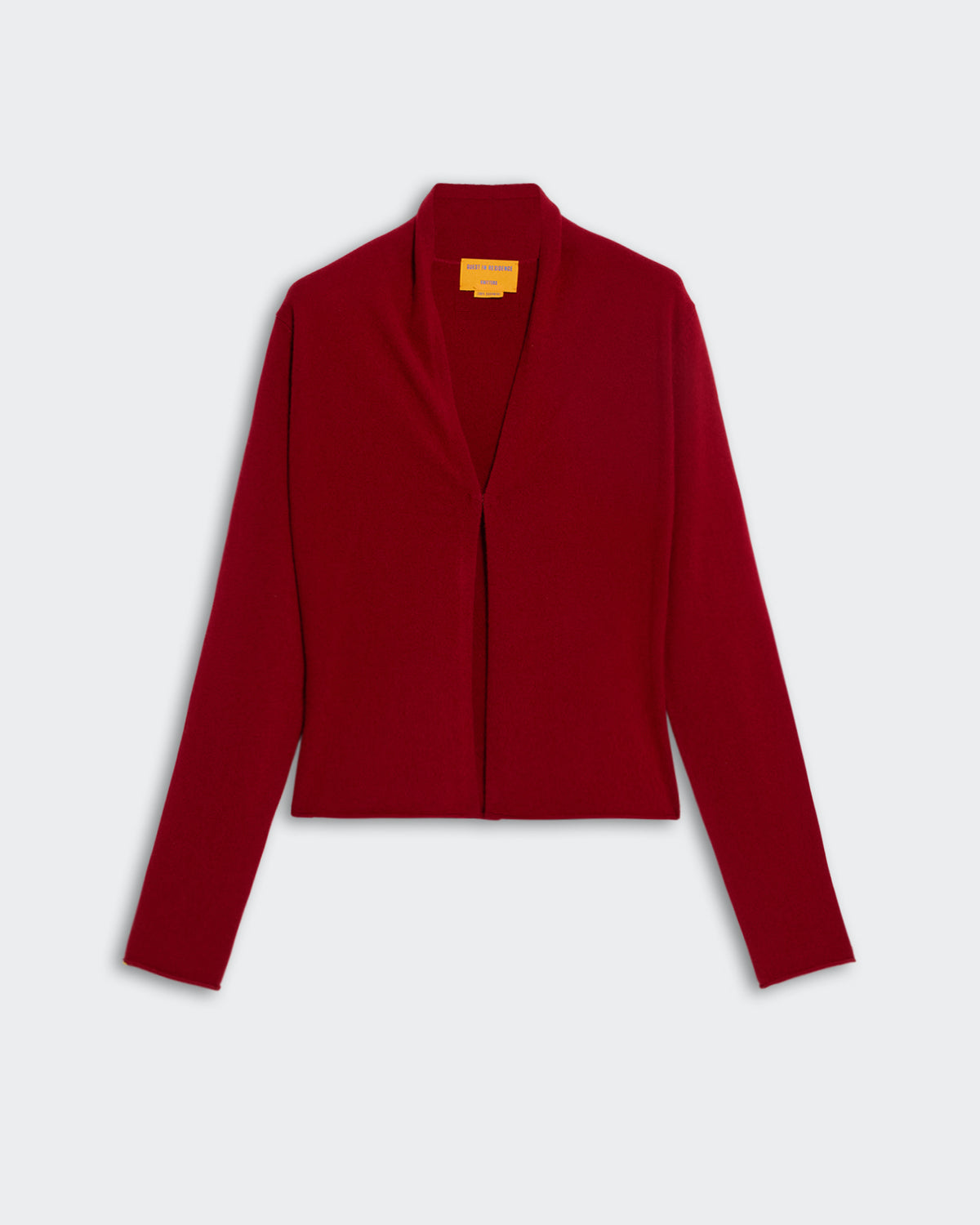 Stealth Cardigan - Ruby in deep red with long sleeves and simple open front design on a plain background