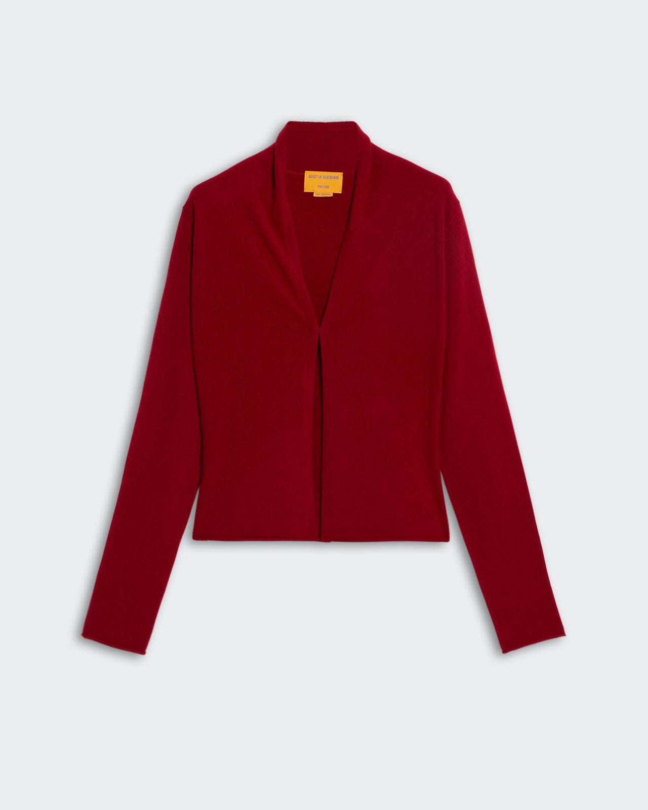 Stealth Cardigan - Ruby in deep red with long sleeves and simple open front design on a plain background
