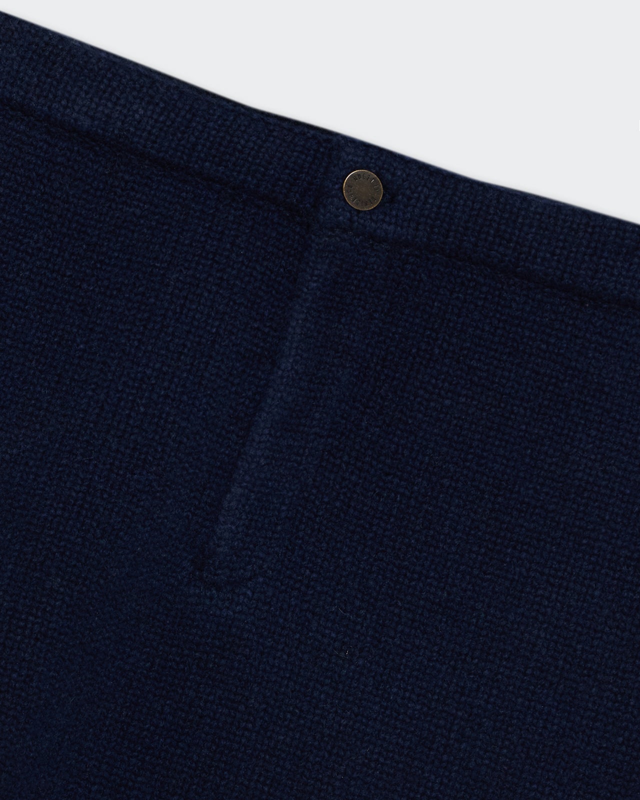 Close-up of the Midnight Jean Mini Skirt showing textured cashmere fabric and classic shank button closure.