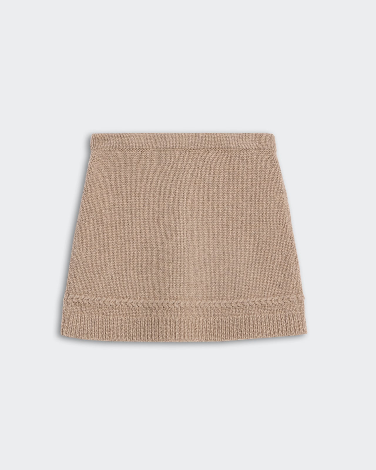 Jean Mini Skirt - Taupe is a knitted taupe-colored mini skirt with a braided detail above the ribbed hemline.