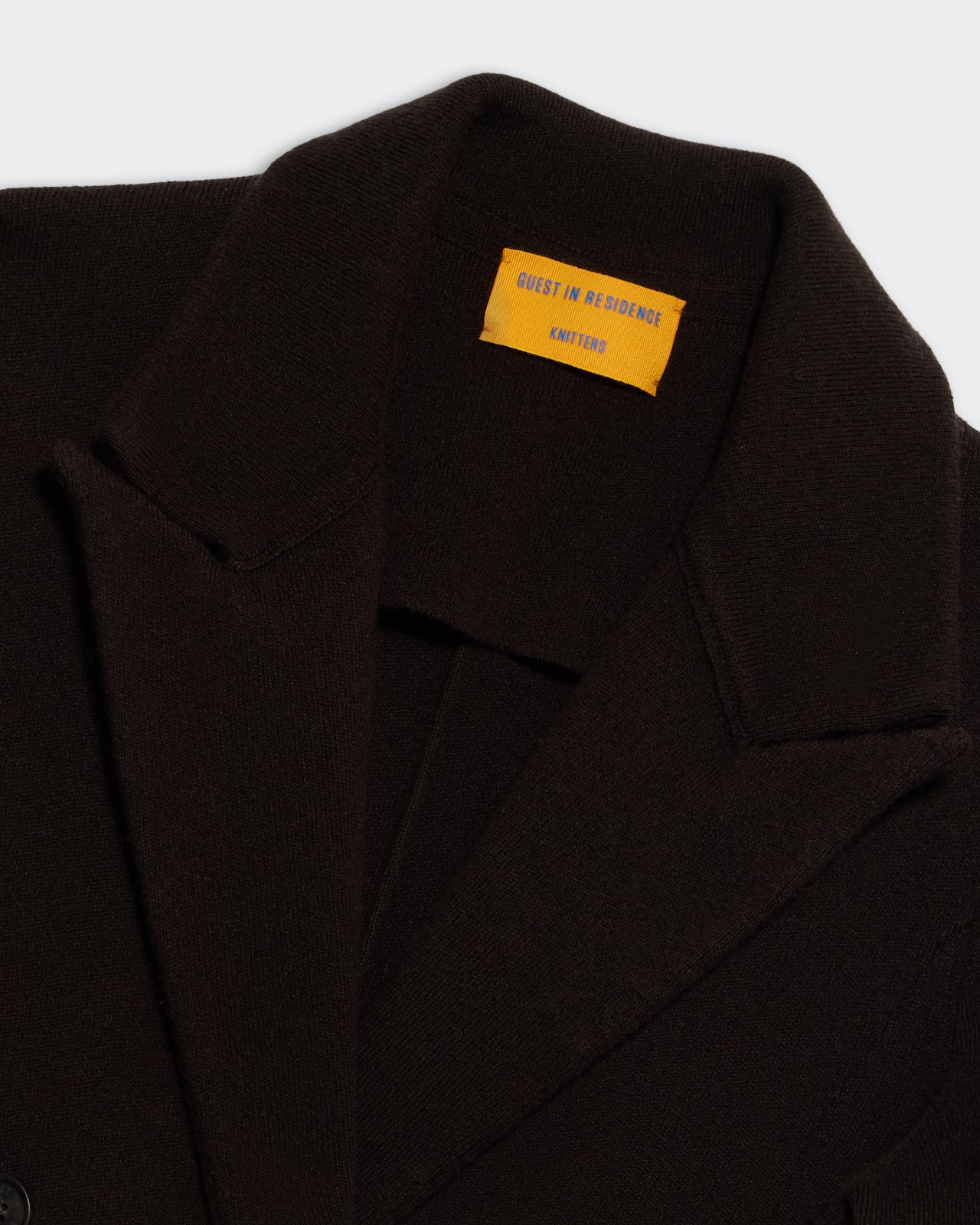 Tailored Blazer - Burnt Cocoa close-up of collar and yellow interior label on dark brown fabric blazer