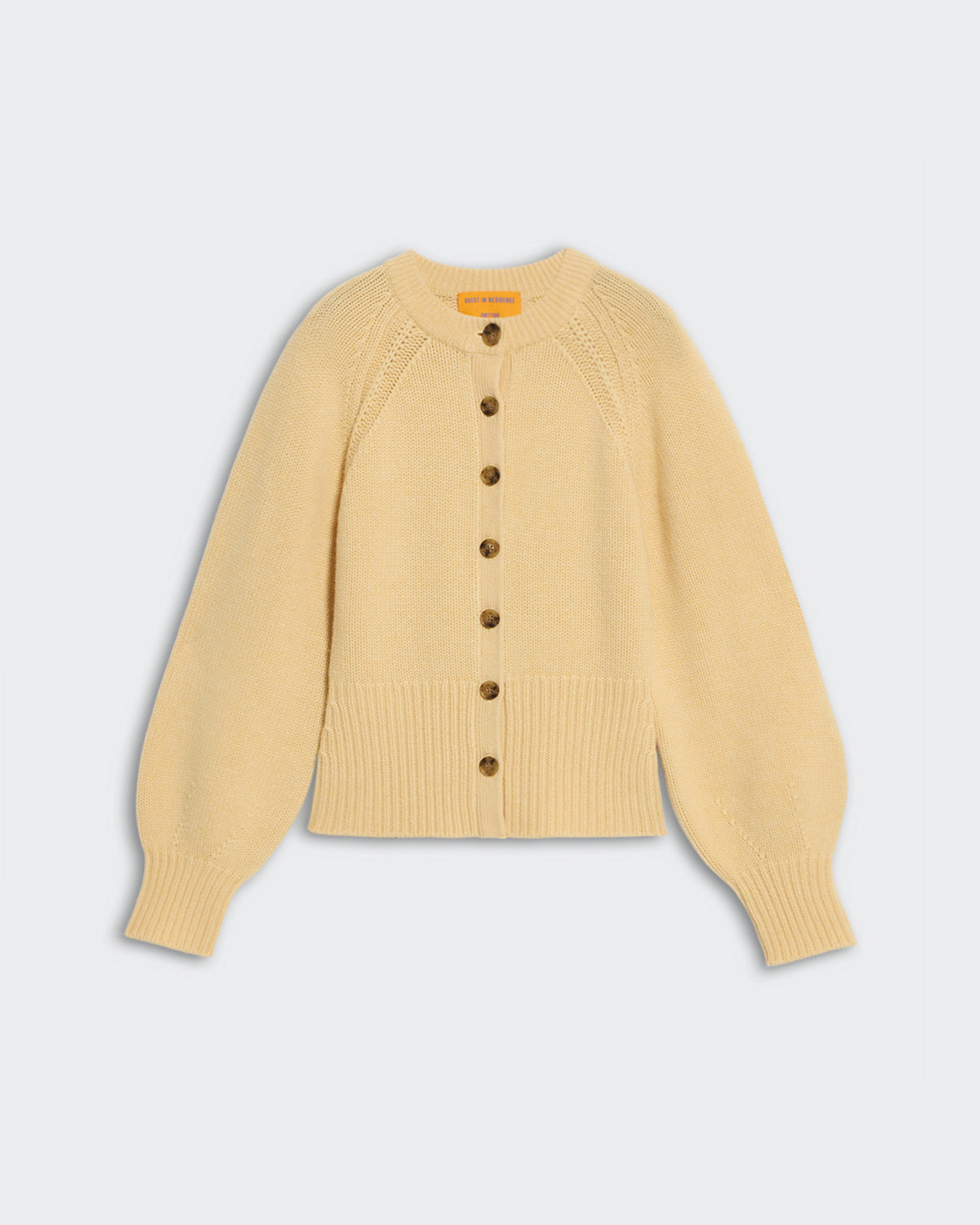 Sculpted Cardigan - Butter cashmere cropped cardigan with puffed sleeves and front button closure in pale yellow.