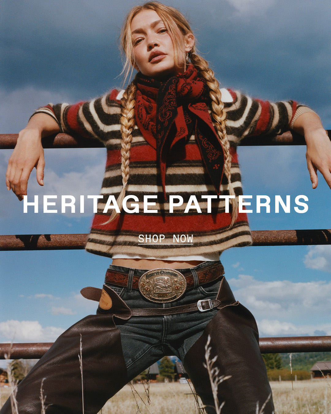 Fashion portrait of a woman wearing a patterned knit sweater and scarf with braided hair and leather trousers against a cloudy sky. Text reads Heritage Patterns Shop Now