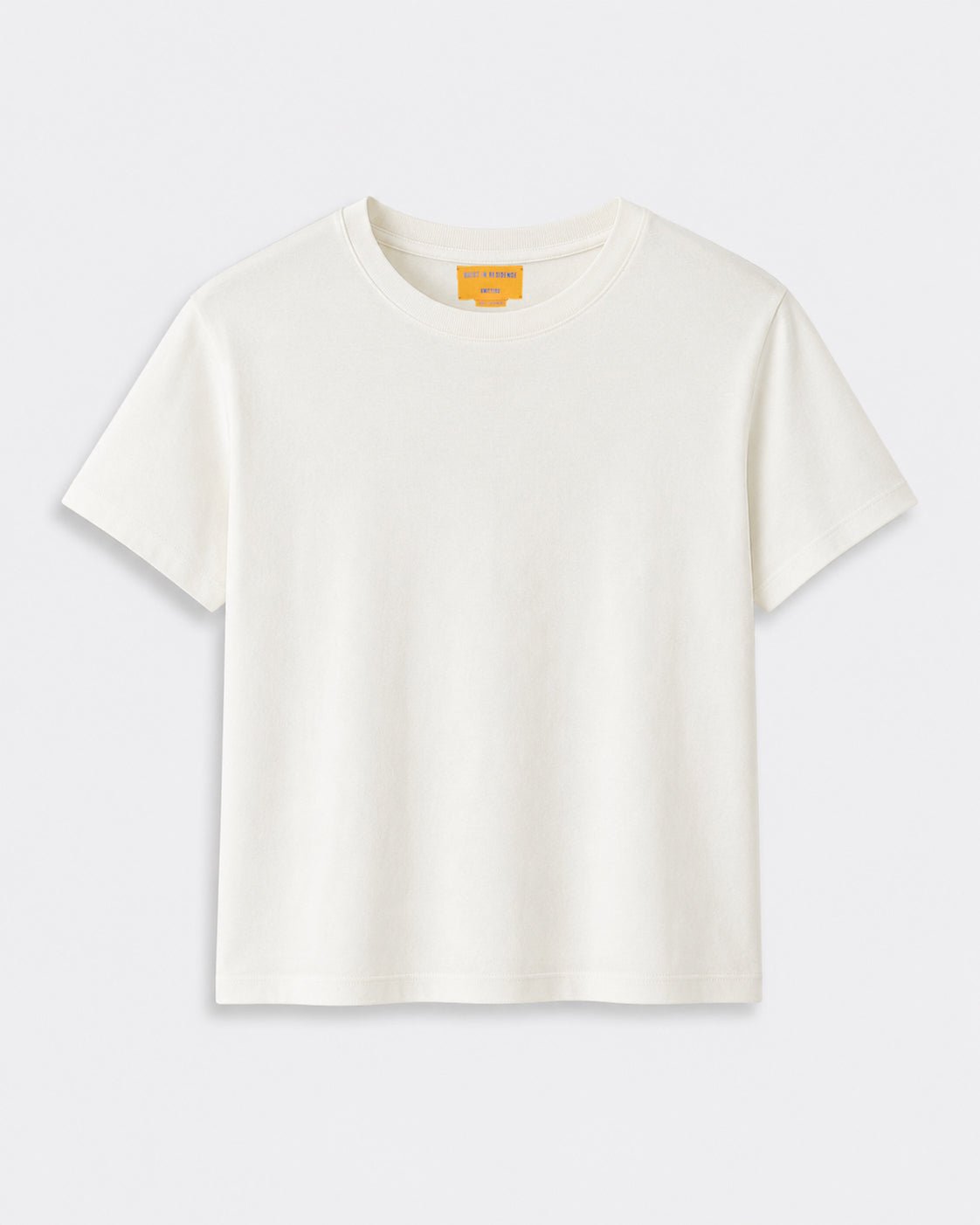 Cropped Tee - Cream short sleeve T shirt displayed flat against a light background with a classic crew neckline and relaxed cropped fit